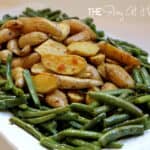 Roasted fingerling potatoes surrounded by green beans with tarragon cream dressing served on a platter