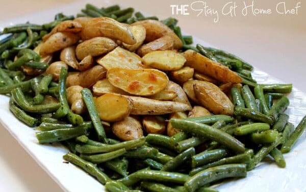 Potatoes and green beans on a white serving dish.