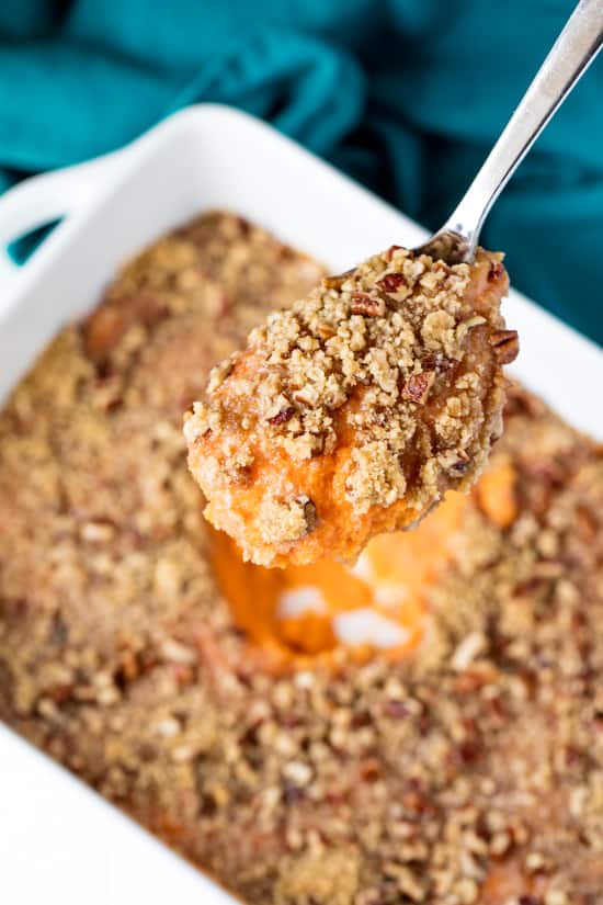 A spoonful of Sweet Potato Casserole lifted from the pan