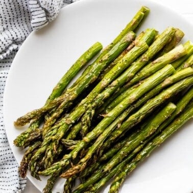 A stack of Roasted Asparagus on a plate