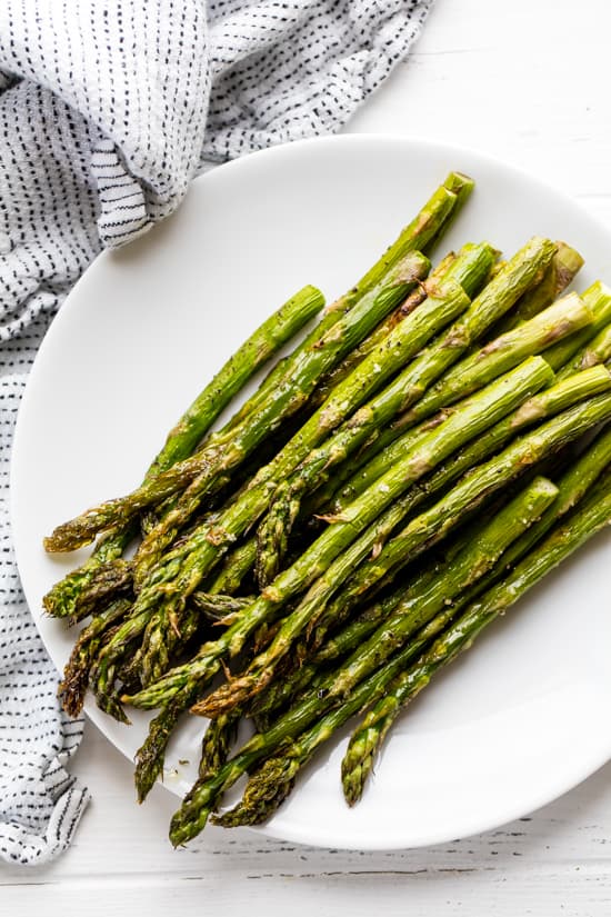 A stack of Roasted Asparagus on a plate