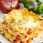 Slice of buffalo chicken lasagna on a white plate.