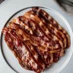 A stack of Candied Bacon on a white plate.