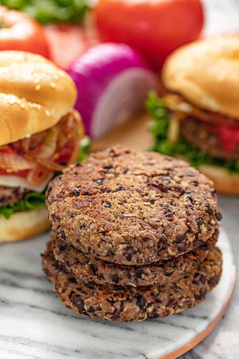 A stack of Black Bean patties on a marble plate.