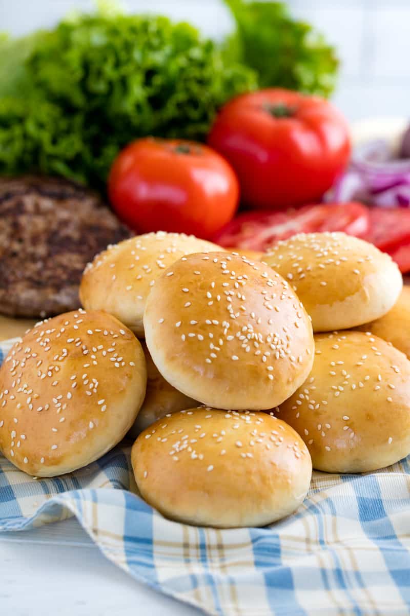 Stack of hamburger buns on a cloth.