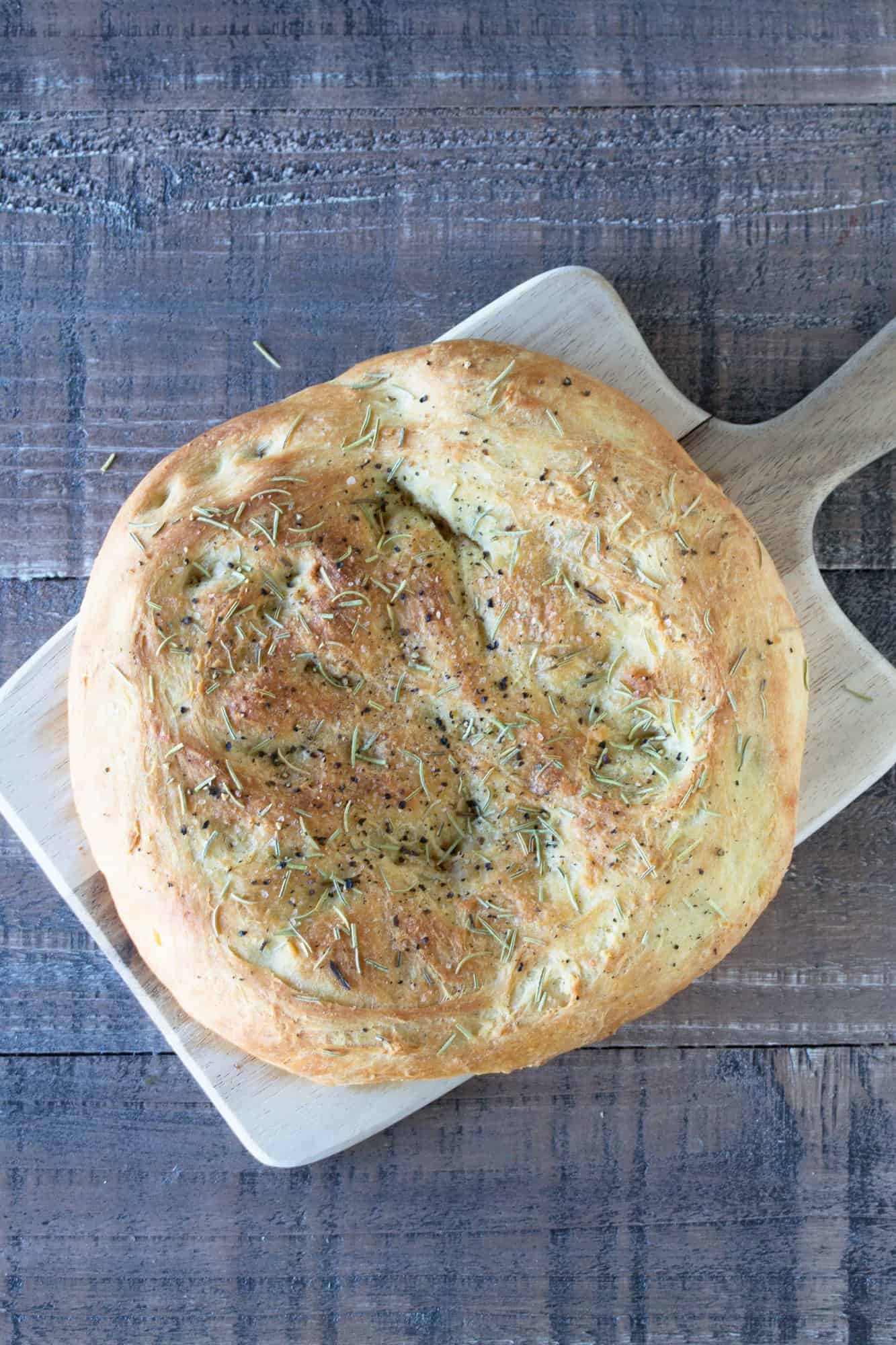 Rosemary Focaccia bread on a cutting board.