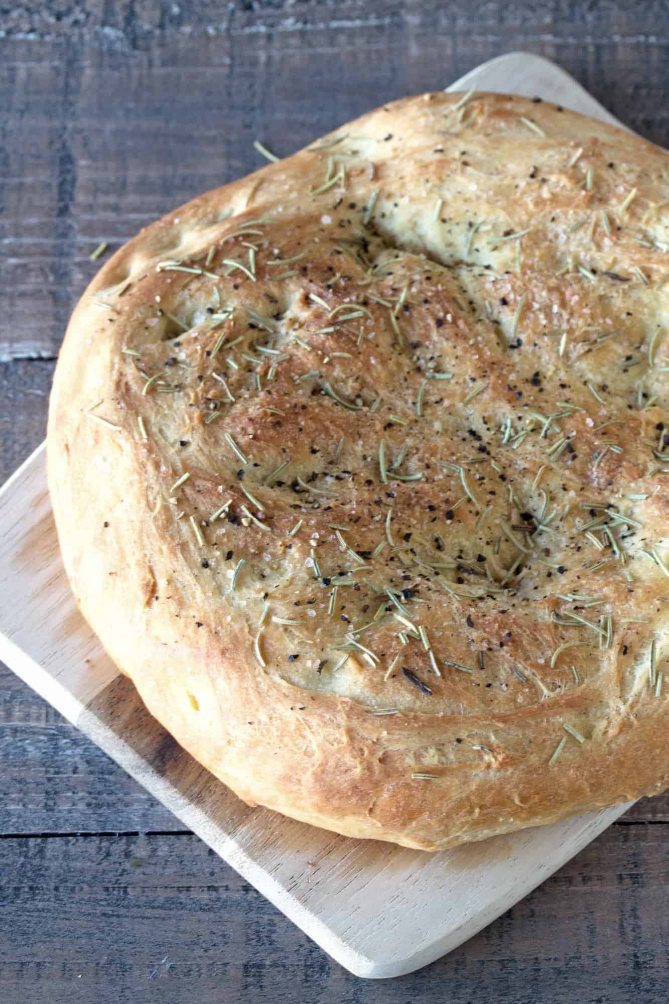 Close up of Rosemary Focaccia bread on a cutting board.