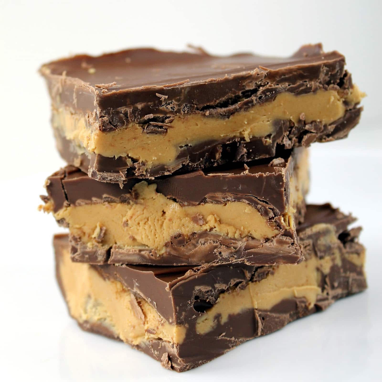 A stack of Peanut Butter Chocolate Bars layered with chocolate and peanut butter goodness