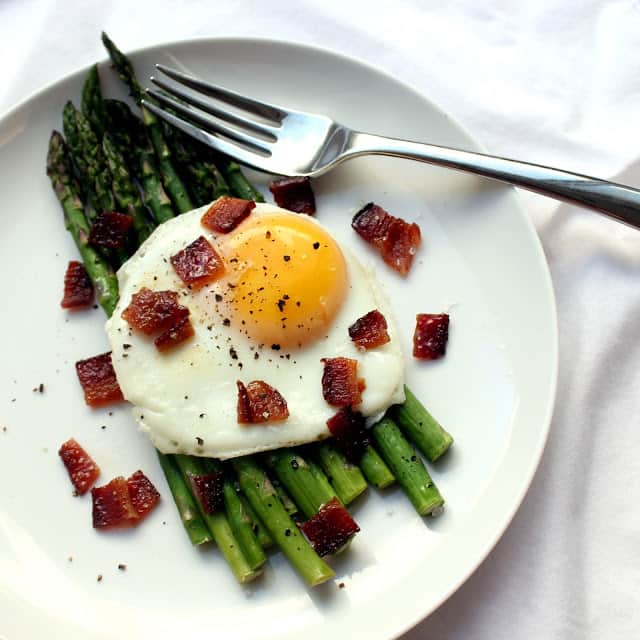 egg over roasted asparagus with candied bacon