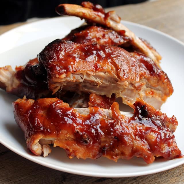 Sliced ribs on a white plate. 