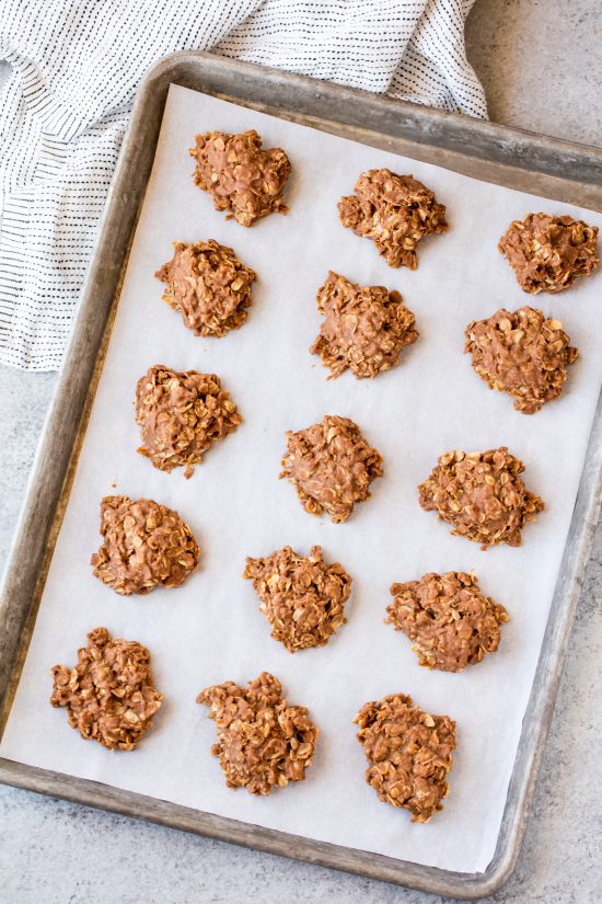 Freshly made Peanut Butter Nutella No Bake Cookies cooling on a parchment paper-lined baking sheet