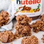 Peanut Butter Nutella No Bake Cookies stacked in front of a jar of nutella