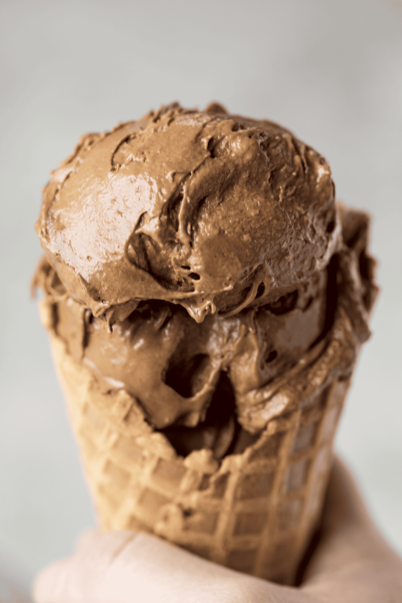 Close up of Chocolate Peanut Butter Banana healthy ice cream in a waffle cone. 