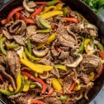 Bird's eye view of Steak Fajitas in a cast-iron skillet.