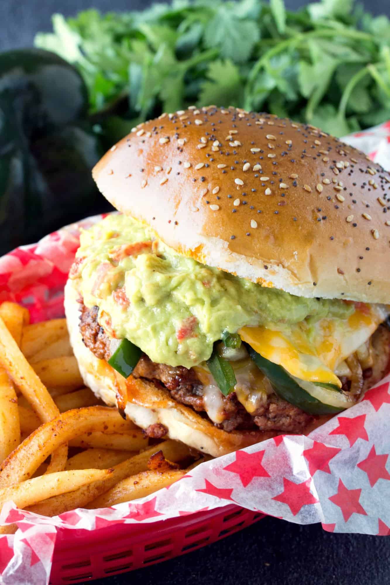 Queso Fundido Chorizo Hamburger in a red basket with fries.