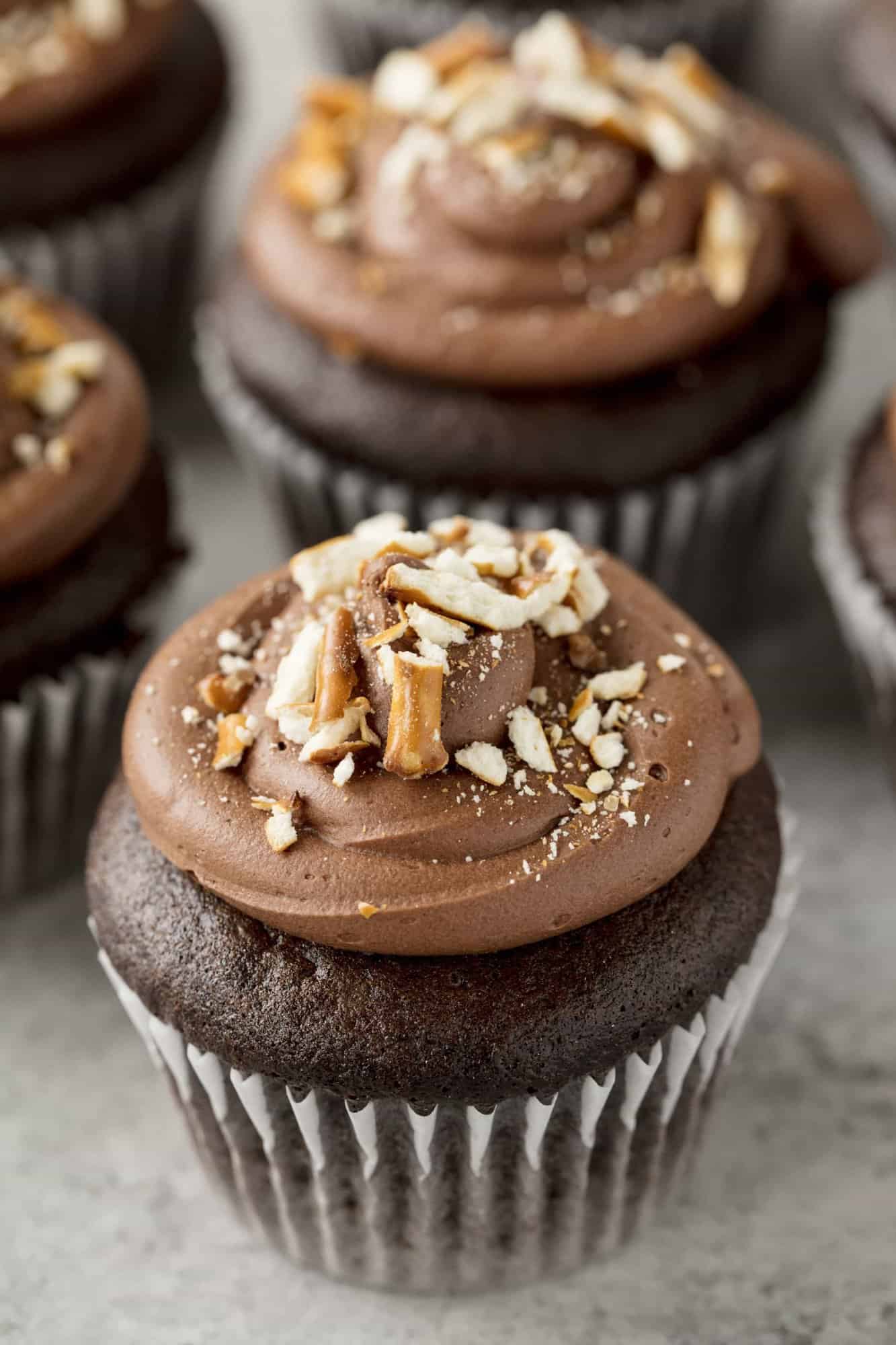 Sinfully decadent chocolate cupcakes filled with a creamy peanut butter filling and topped with whipped chocolate ganache and crushed pretzel. These Chocolate Peanut Butter Pretzel Cupcakes are out of this world!
