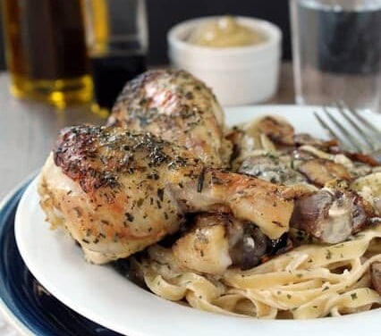 Tarragon Dijon Chicken on some pasta on a white plate.