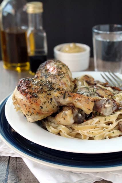 Tarragon Dijon Chicken on some pasta on a white plate.