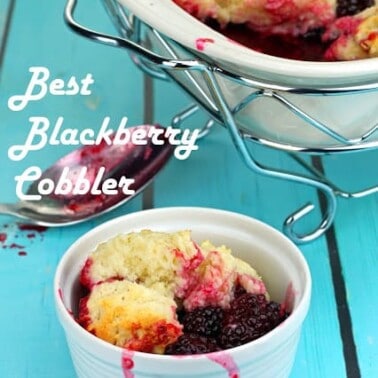 Blackberry Cobbler in a small white bowl with the worlds Best Blackberry Cobbler above it.