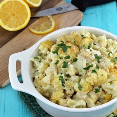 Creamy Oven Roasted Cauliflower in a white baking dish.