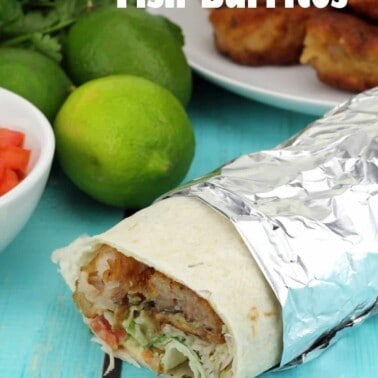 Battered Fish Burritos with Green Chile Sauce cut open to show the insides and wrapped in foil