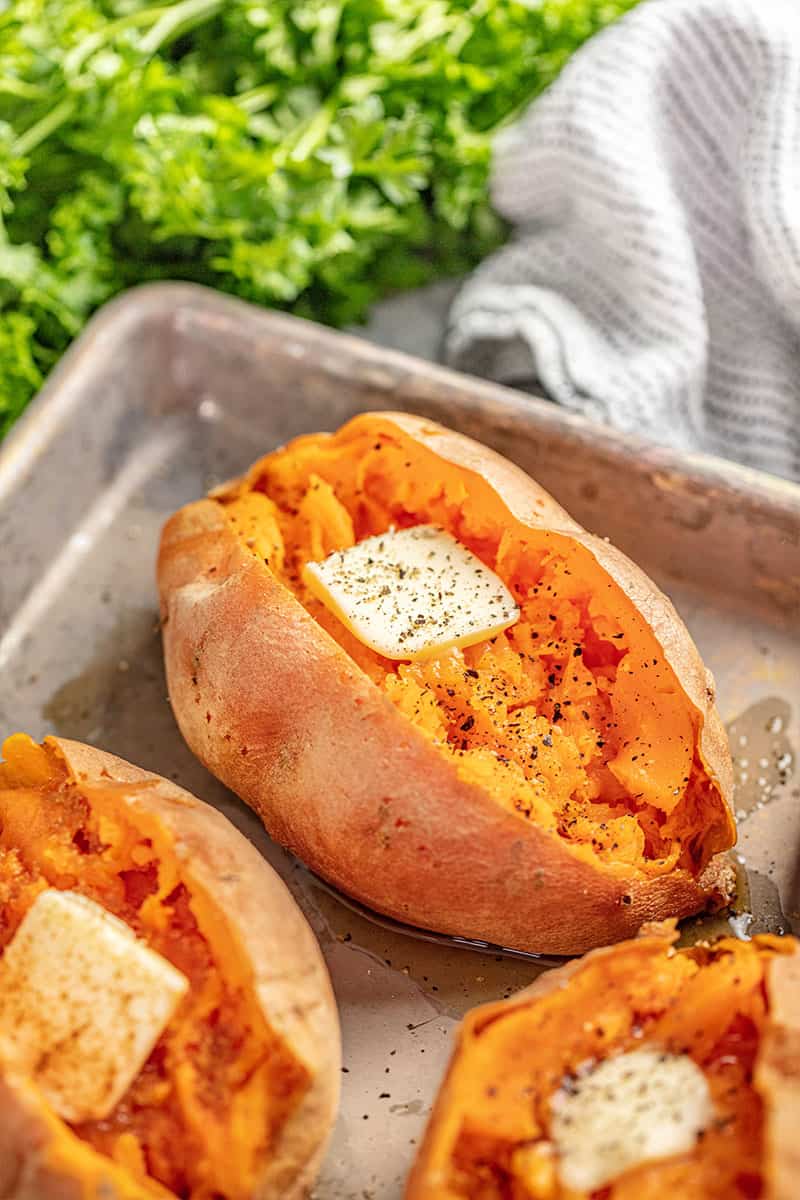 Close up of a Baked Sweet Potatoe on a baking sheet.