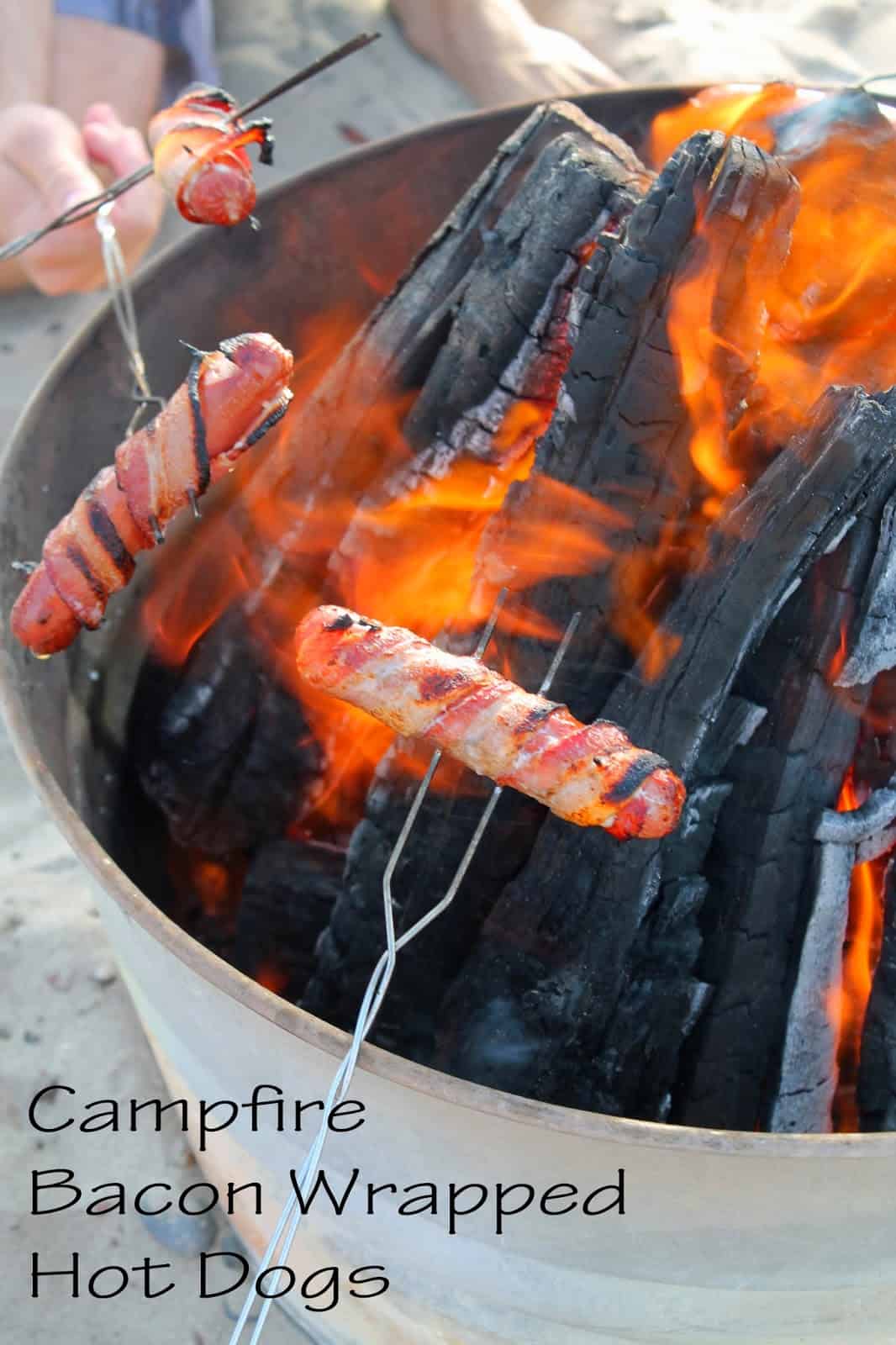 bacon wrapped hot dogs  cooked over a campfire