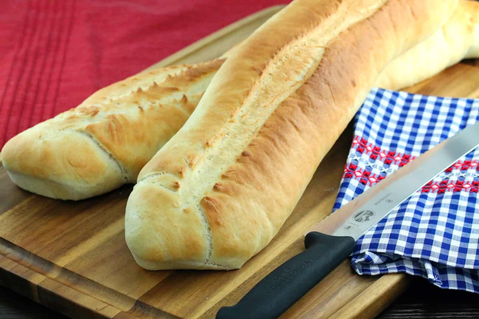 Loaves of fresh DIY Homemade Cuban Bread on a cutting board