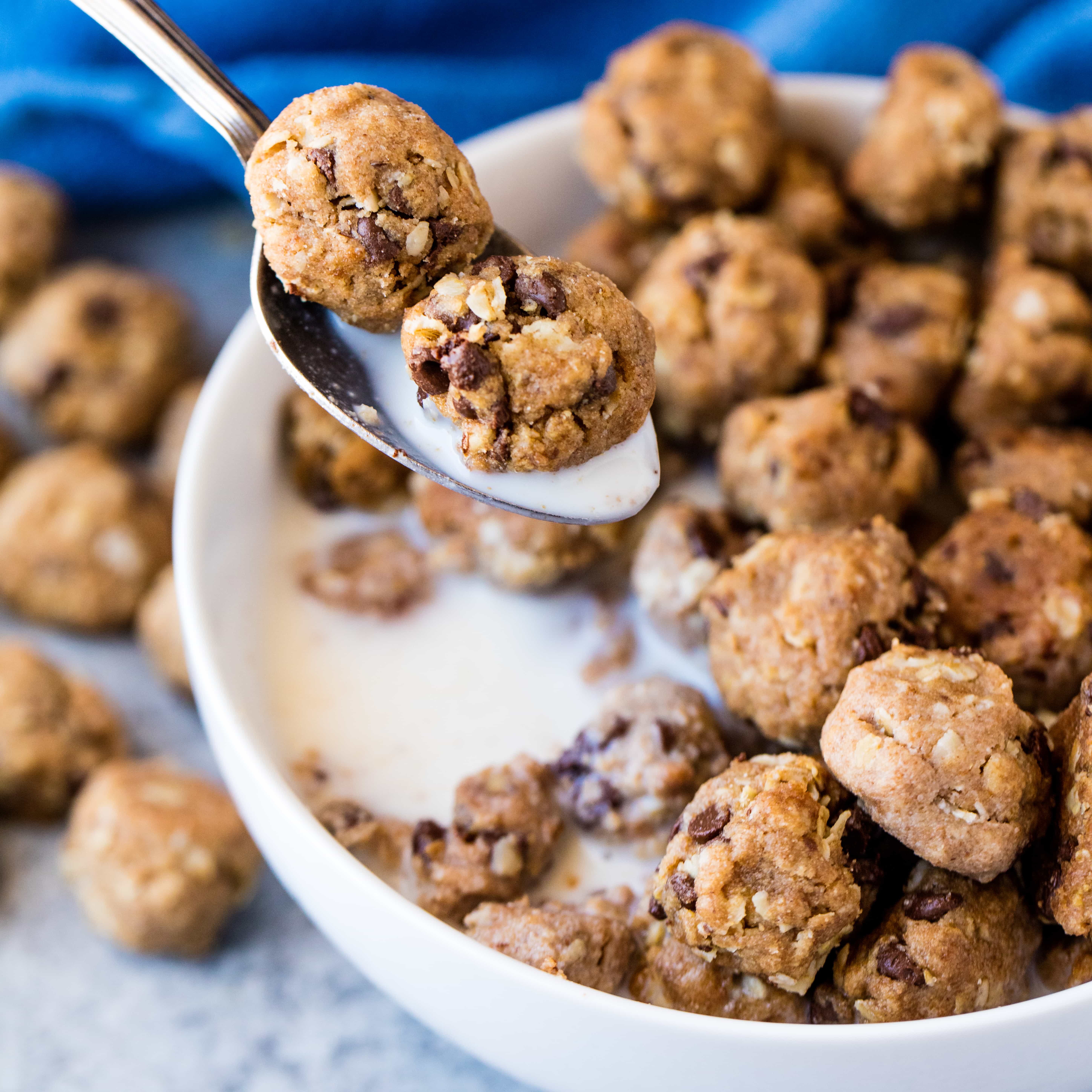A spoonful of homemade cookie cereal and milk is taken from a bowl of cookie cereal