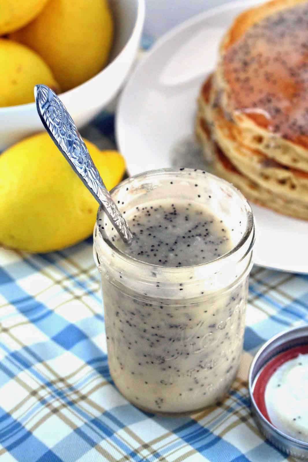 Lemon poppyseed buttermilk syrup in a mason jar with spoon in jar