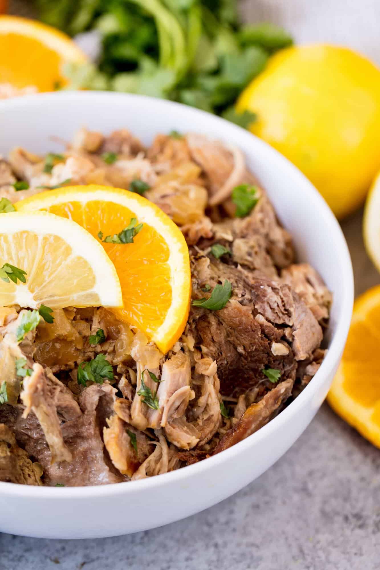 Slow Cooker Cuban Mojo Pork is tender shredded pork, slow cooked in a garlic citrus sauce. Serve it up on some toasted bread for a delicious Cuban sandwich or plain with rice and beans.