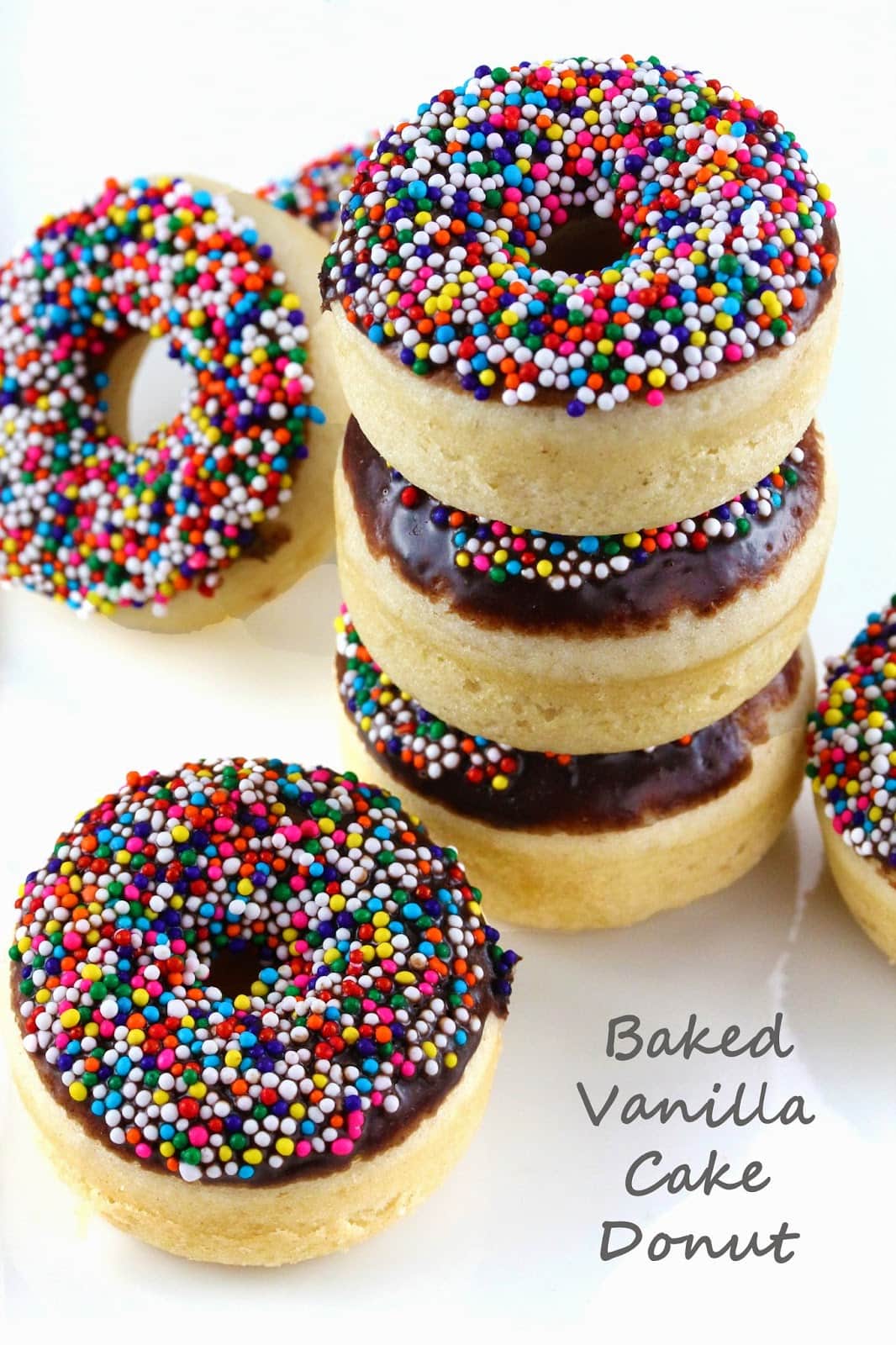 Baked vanilla cake donuts topped with a semi-sweet chocolate glaze and sprinkles. You can't go wrong with sprinkles!