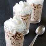 Three Nutella Mousse in glasses topped with whipped cream.