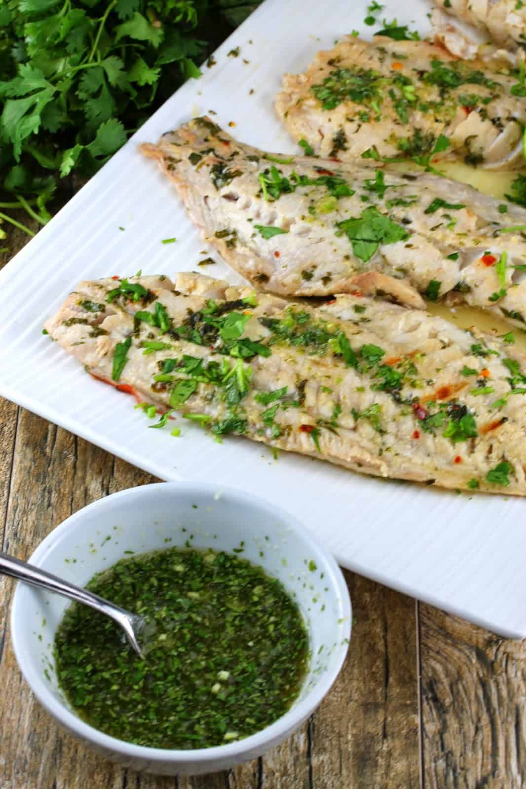 Thai grilled fish with green dipping sauce on the side