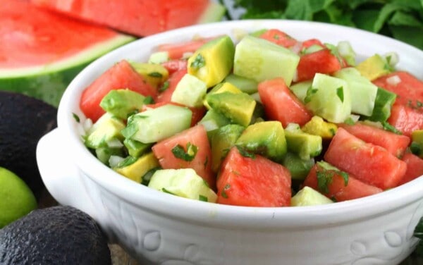 Watermelon, Avocado, Cucumber Salad in a white bowl.