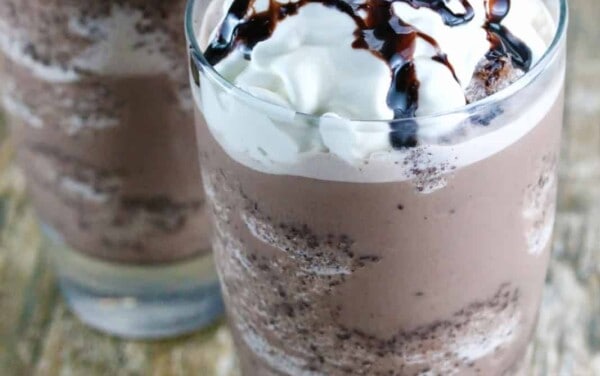 Two Homemade Chocolate Chip Frappes on a wood countertop.