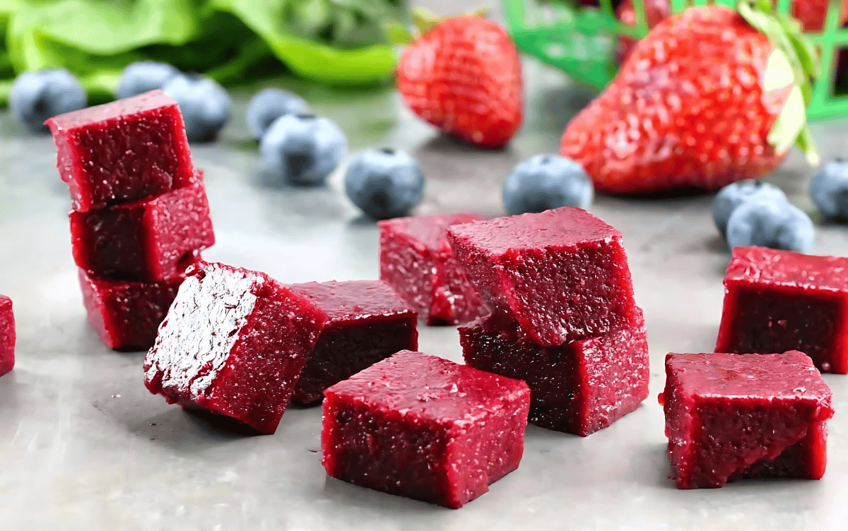 Cubes of Homemade Fruit Snacks stacked on a counter.