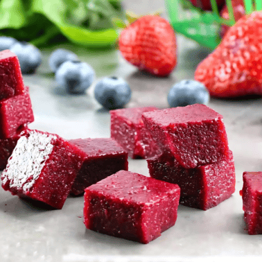 Cubes of Homemade Fruit Snacks stacked on a counter.