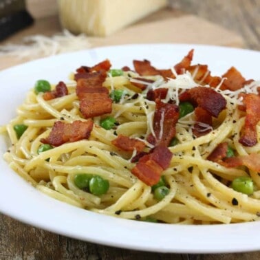 Quick Bacon and Pea Pasta on a white plate.