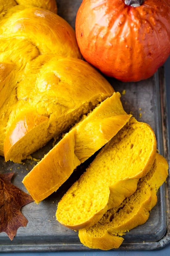 An overhead view of a braided pumpkin bread that has been sliced.