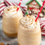 Gingersnap Frappe in two glasses with red polka dot straws, topped with whipped cream and dusted with cinnamon