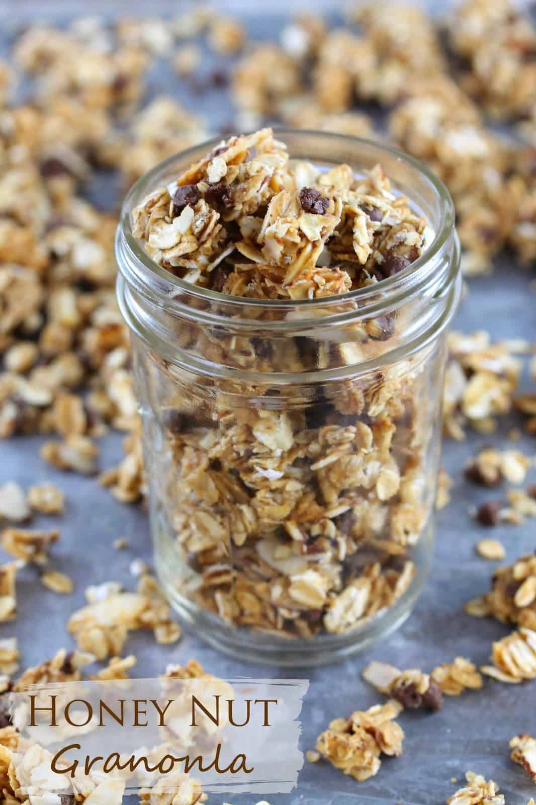 Honey Nut Granola: clusters of granola made from oats, honey, peanut butter, slivered almonds, chocolate chips and other simple ingredients fill a mason jar. 