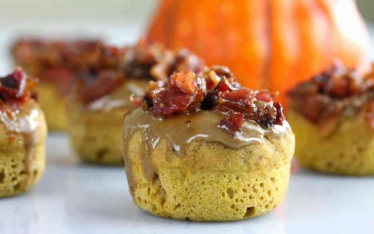 Maple Bacon Pumpkin Donut with a pumpkin in the background.