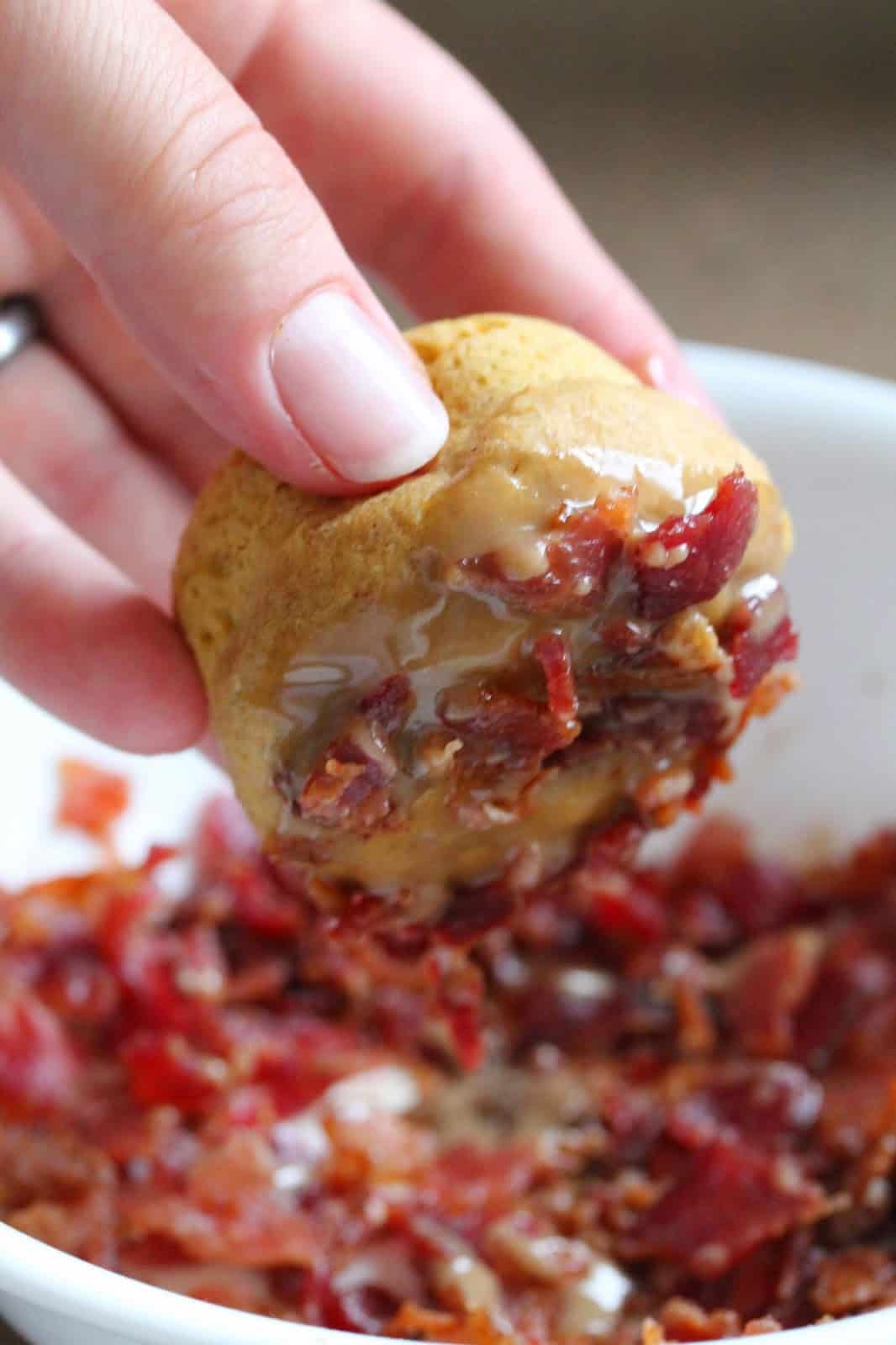 When the donuts are finished baking, remove from pan and one at a time dip into maple glaze and then into bacon crumbles. Set on a cooling rack to cool.