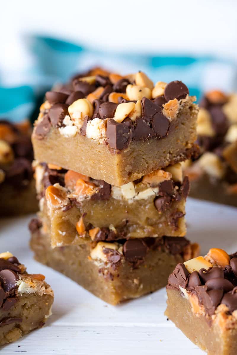 A stack of Slow Cooker Cookie Bars loaded with white chocolate and chocolate chips.