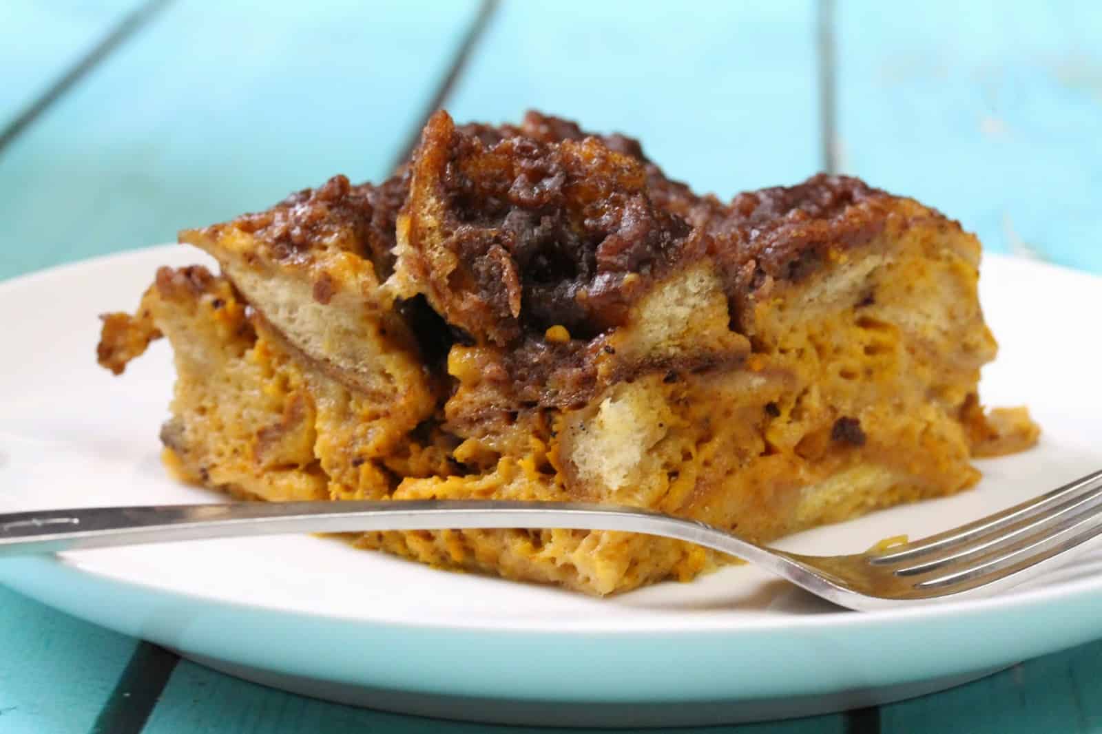 Slow Cooker Pumpkin French Toast on a white plate with a fork.