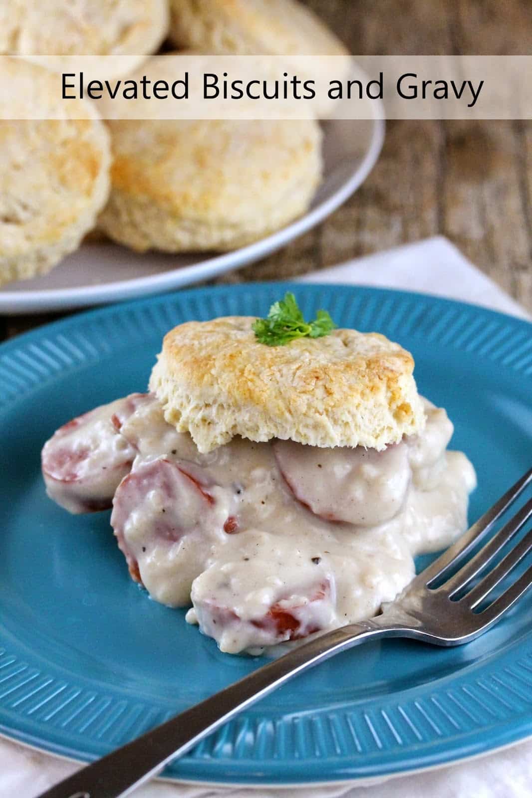 Elevated Biscuits and Gravy: Gravy with slices of sausage is topped with a homemade biscuit and garnished with parsley