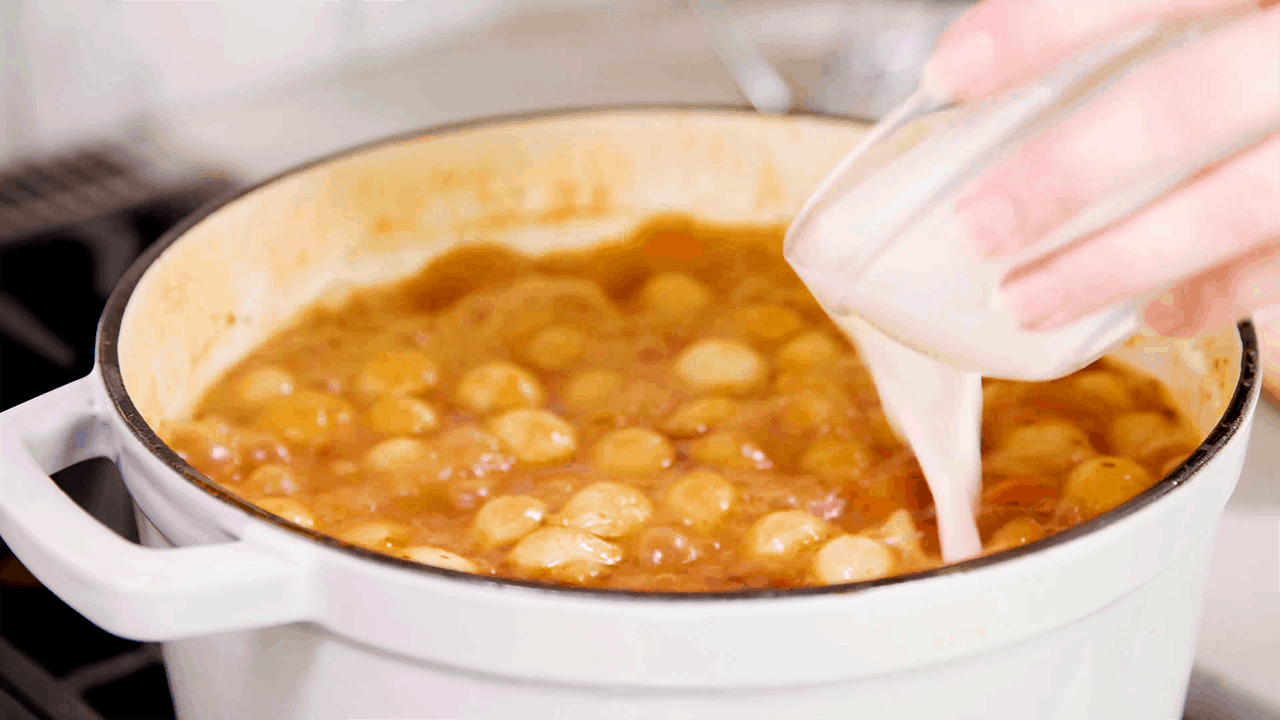 Pour cornstarch slurry into stew to thicken