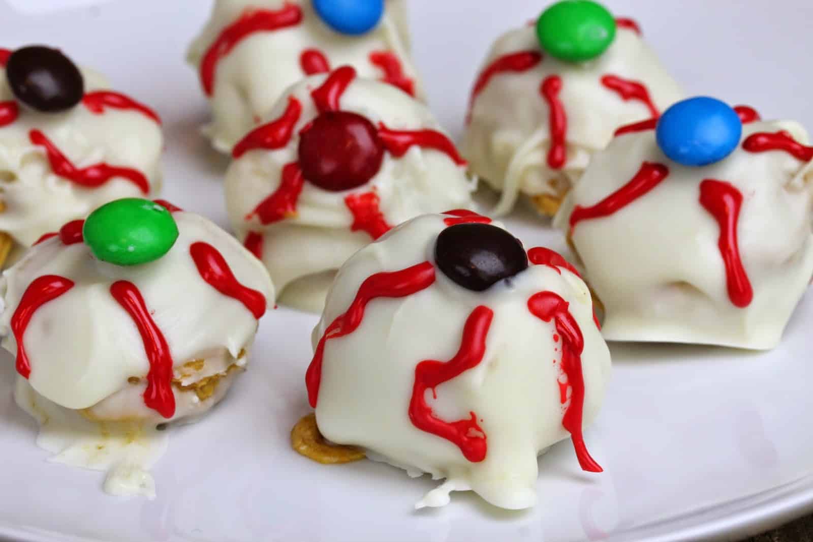 Pumpkin Truffle Eyeballs on a white plate.