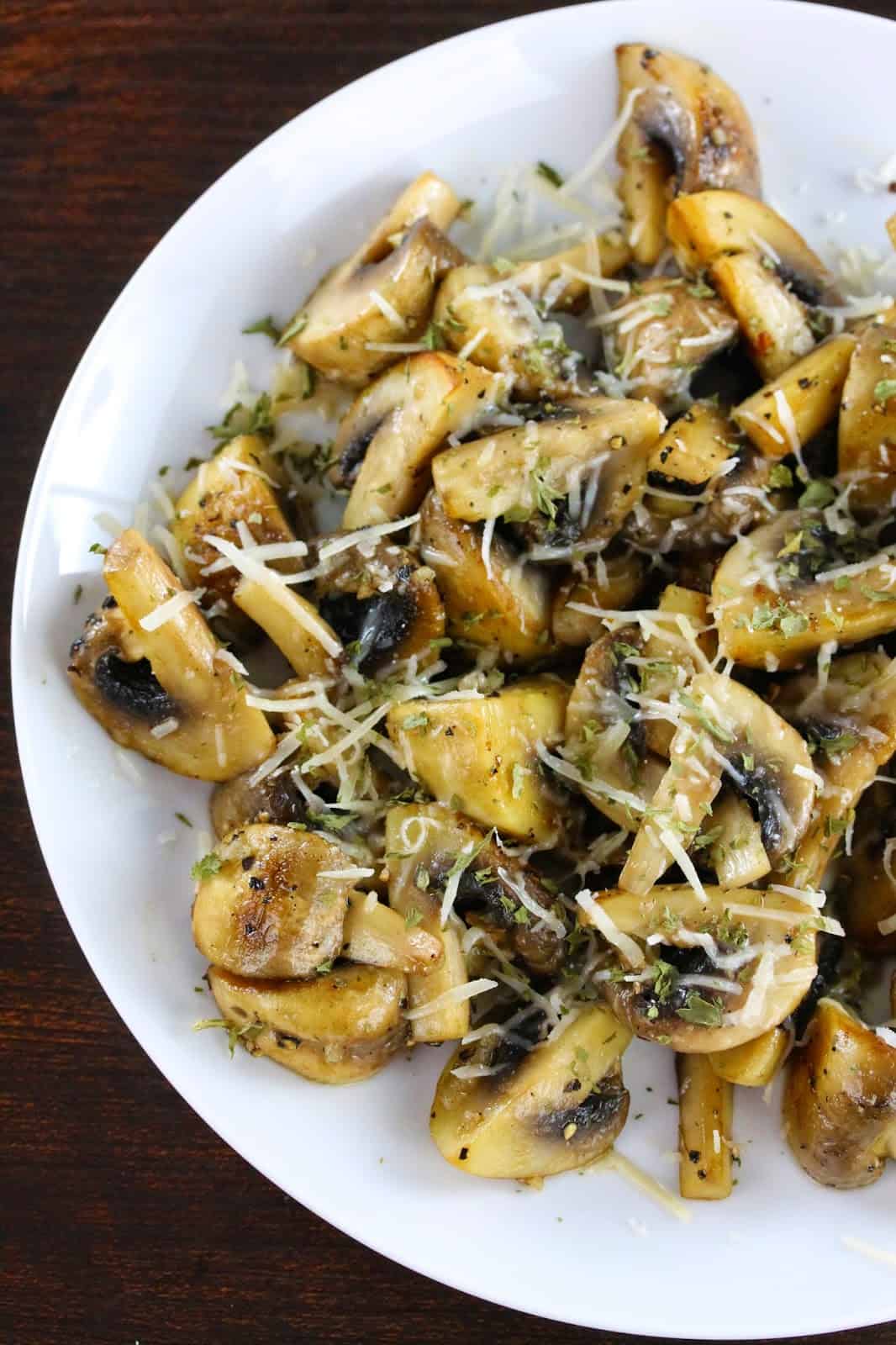 Sauteed Mushrooms with Garlic and Parmesan on a white plate.